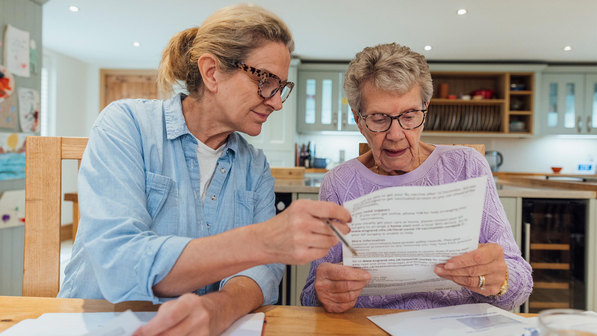 Daughter helping her mother with retirement paperwork
