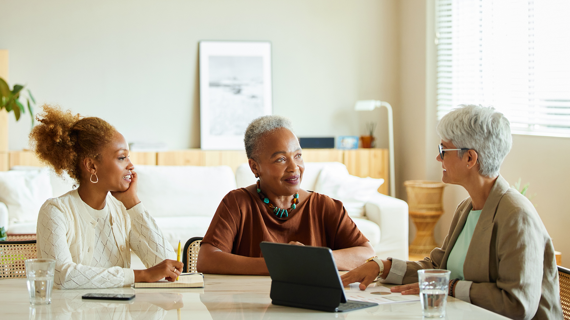 An eldery woman and her daughter meeting with a retirement advisor
