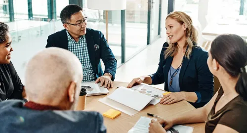 A group of employees meeting together in a conference room