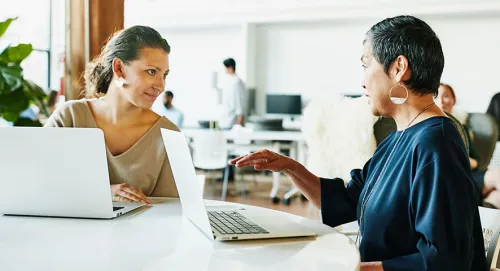 A female advisor speaking with her elderly retiree client