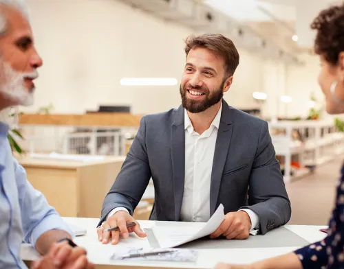 Advisor smiling with elderly clients