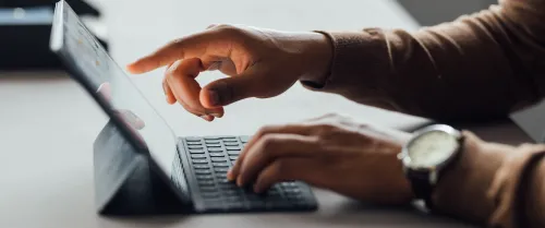 Man typing on his ipad