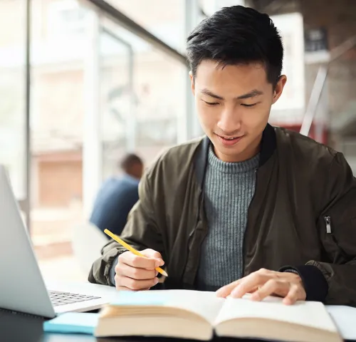 Asian male in his mid 30's studying for an exam